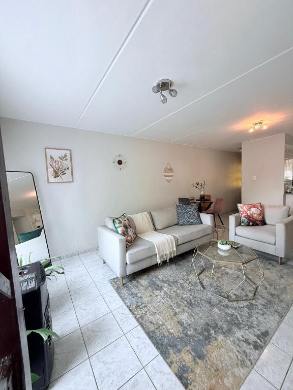 a living room with a couch and a table at Charming Hideaway in Sandton