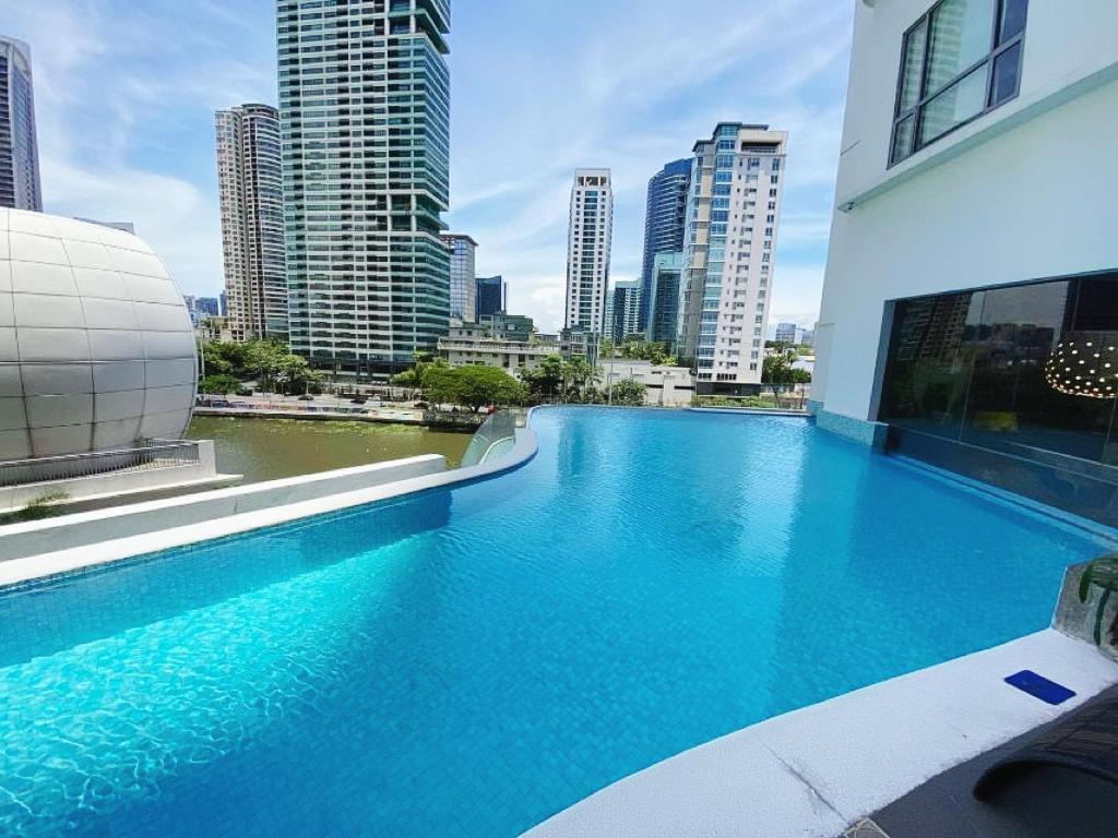 a swimming pool with a view of a city at The Hotel Residences at Acqua in Manila