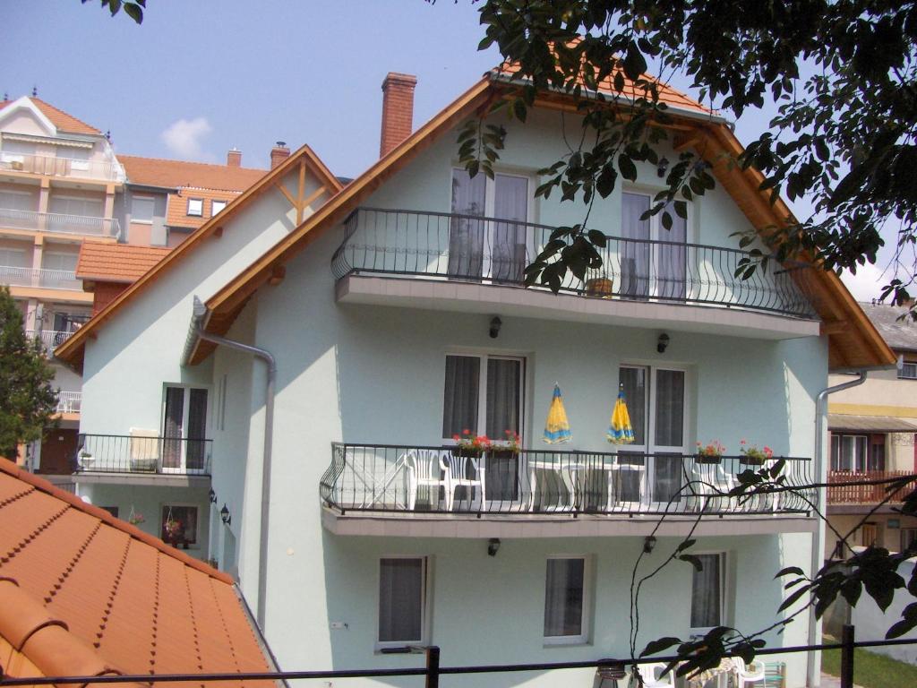 ein weißes Gebäude mit zwei Balkonen darauf in der Unterkunft Zsanett Appartement in Hévíz