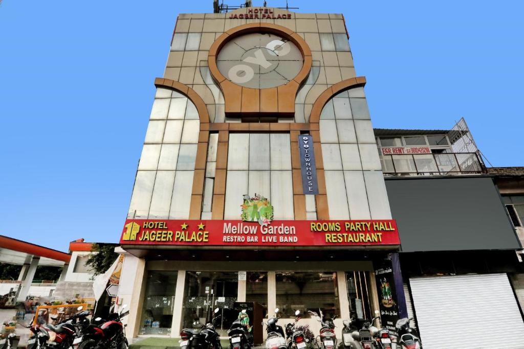 a building with a clock on the front of it at Townhouse Jp Grand Near Mayapuri Chowk in New Delhi