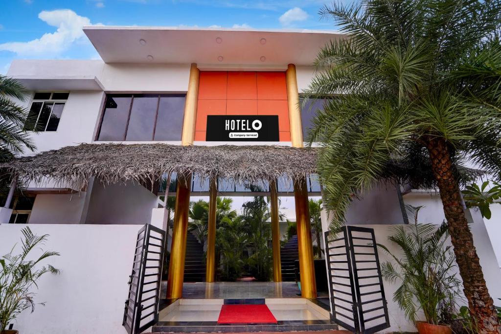 a hotel with a sign on the front of it at Super Hotel O Auroville Bird Sanctuary Chennai Formerly Vanam Resort in Puducherry