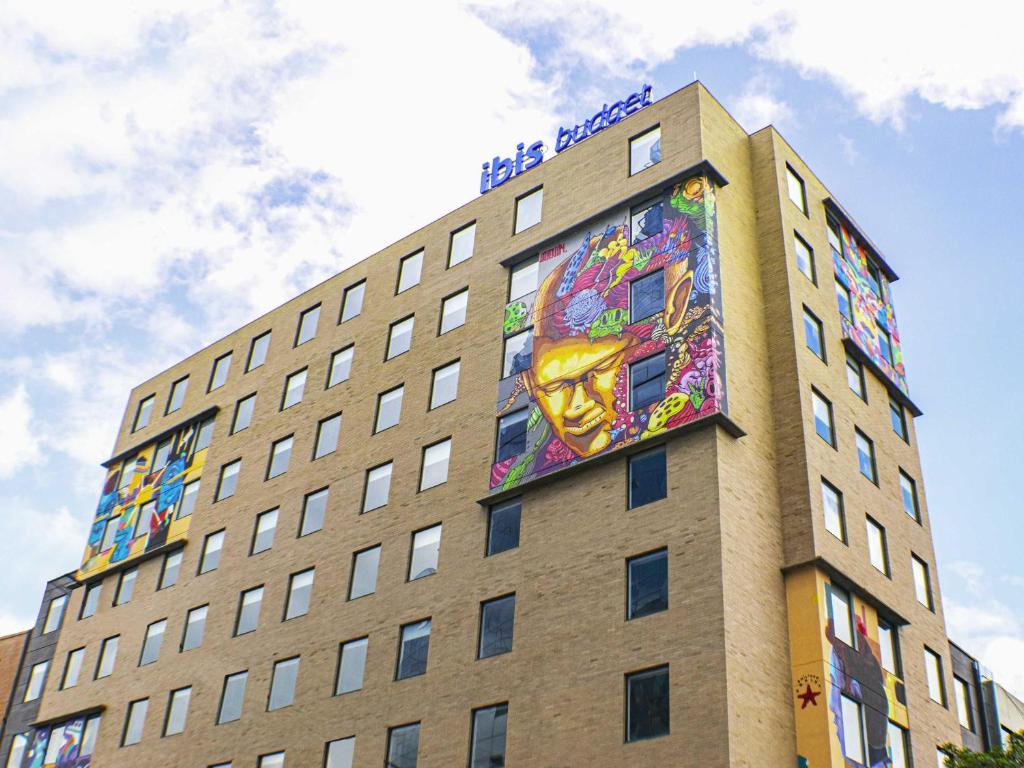 a building with a painting on the side of it at ibis budget Bogota Marly in Bogotá
