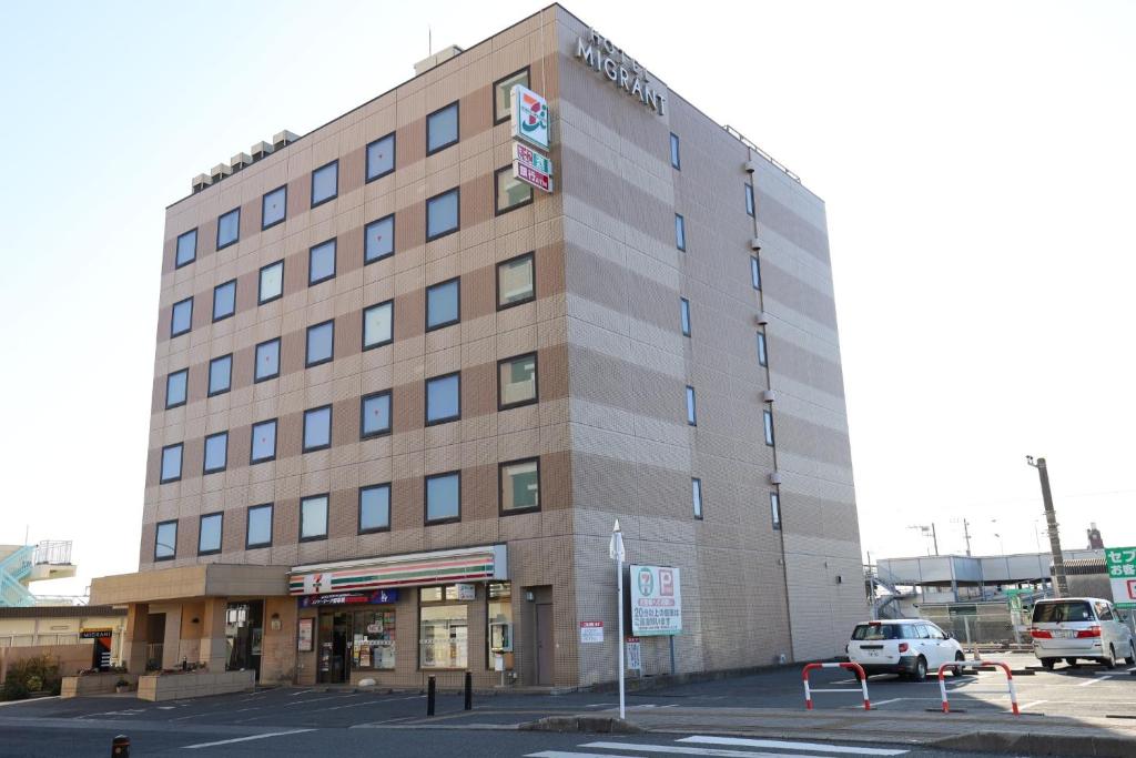 a building with a car parked in a parking lot at Hotel Migrant - Vacation STAY 81252v in Tateyama