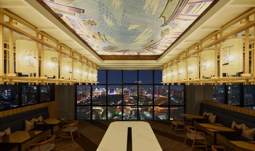 a restaurant with a view of a city at OMO3 Asakusa by Hoshino Resorts in Tokyo