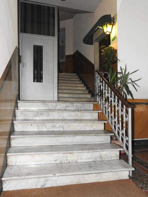 a set of stairs leading to a white door at Albergo Annabella in Santa Margherita Ligure