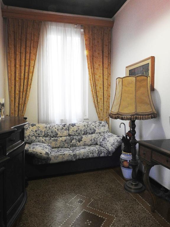 a living room with a couch and a window at Albergo Annabella in Santa Margherita Ligure