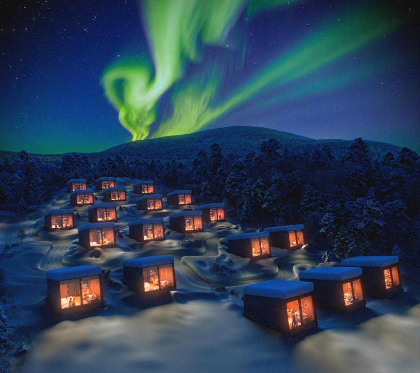 an image of a village under the northern lights at night at Jeris Lakeside Resort in Muonio