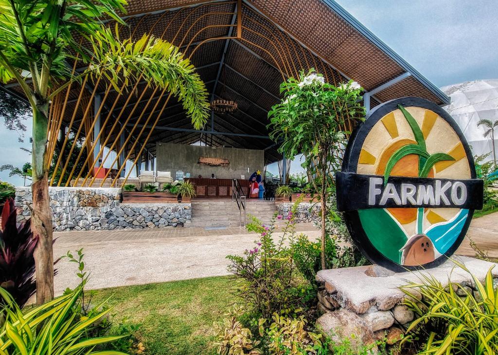 a sign for a farmmo restaurant in front of a building at FarmKO Glamping in Dolores