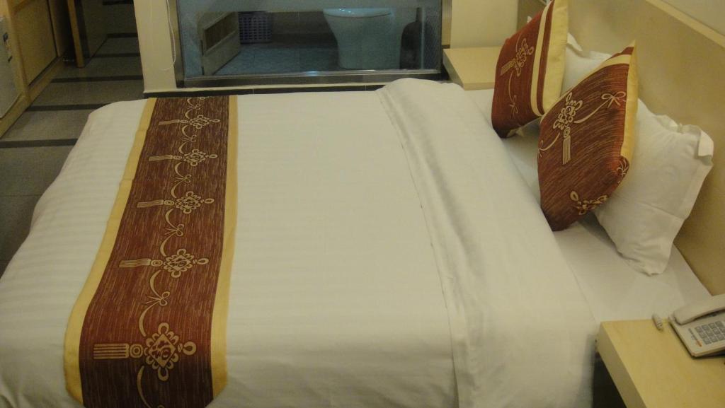 Postel nebo postele na pokoji v ubytování Guang Dong Hotel