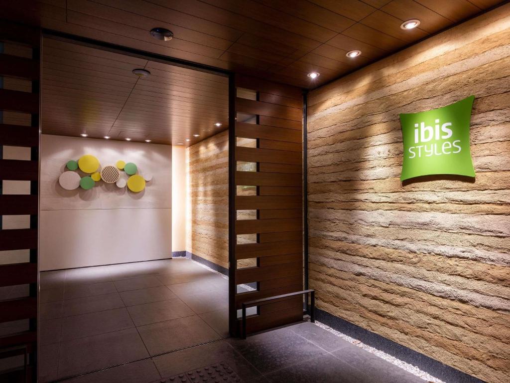 a building with a bus slips sign on the wall at ibis Styles Kyoto Shijo in Kyoto