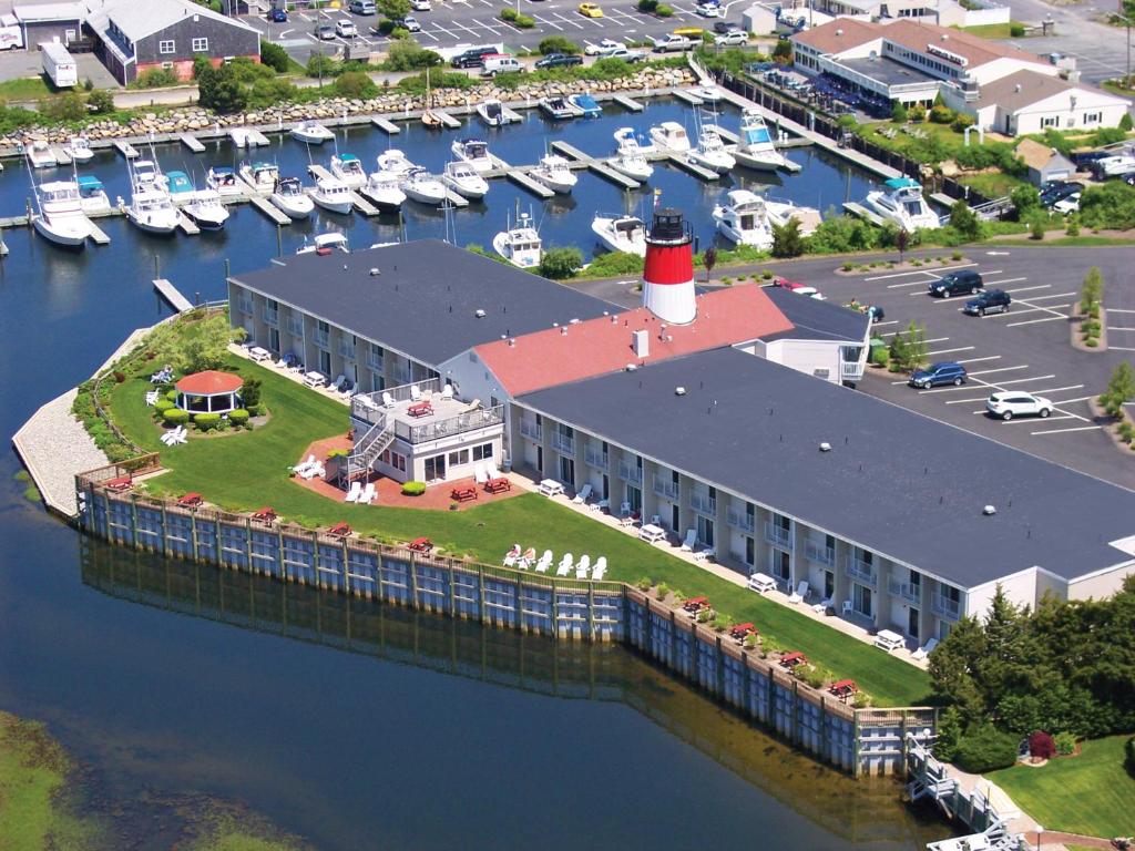 a large building with a lighthouse on an island in the water at Riverview Resort, a VRI resort in South Yarmouth