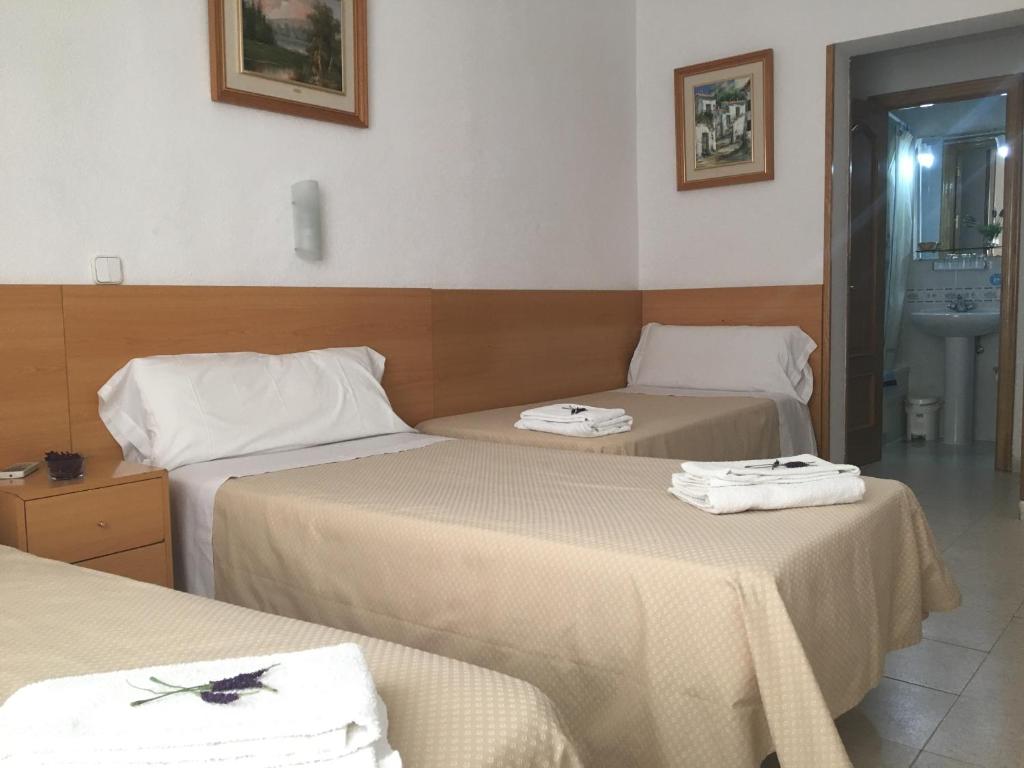 Postel nebo postele na pokoji v ubytování Hostal R. Lido