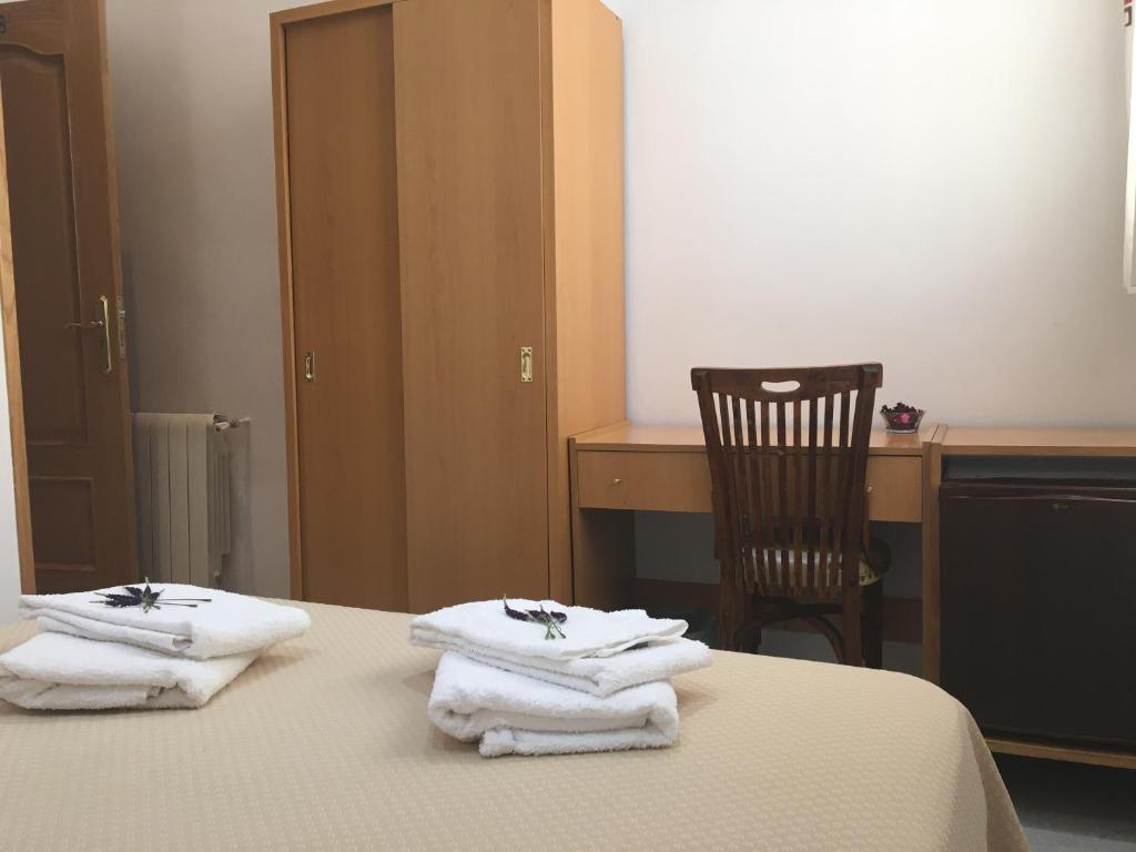 Postel nebo postele na pokoji v ubytování Hostal R. Lido