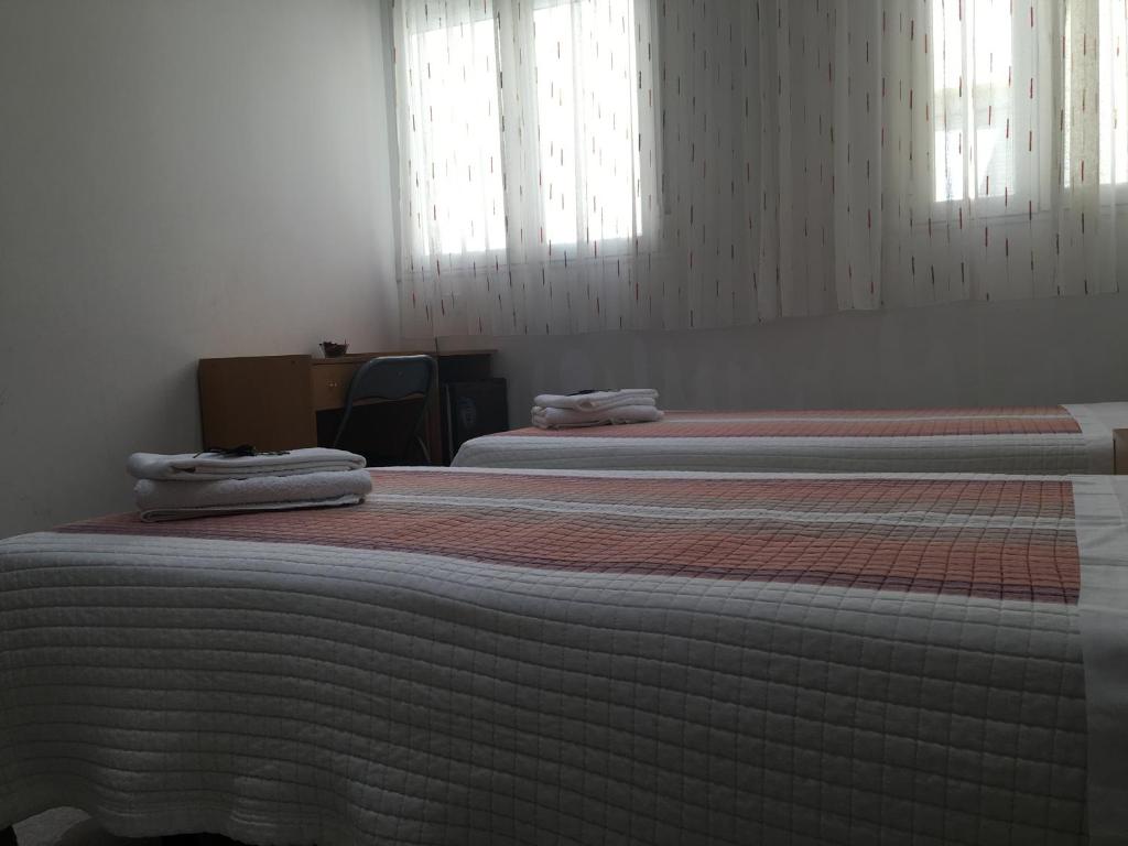 Postel nebo postele na pokoji v ubytování Hostal R. Lido