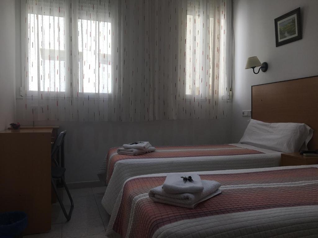 Postel nebo postele na pokoji v ubytování Hostal R. Lido