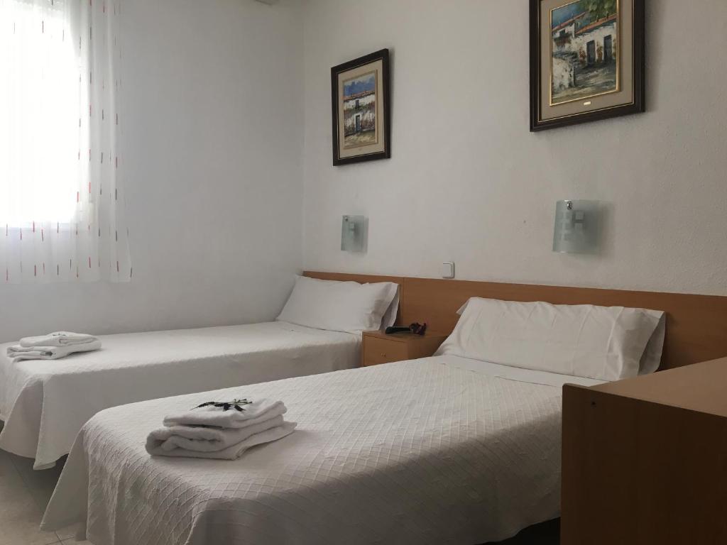 Postel nebo postele na pokoji v ubytování Hostal R. Lido