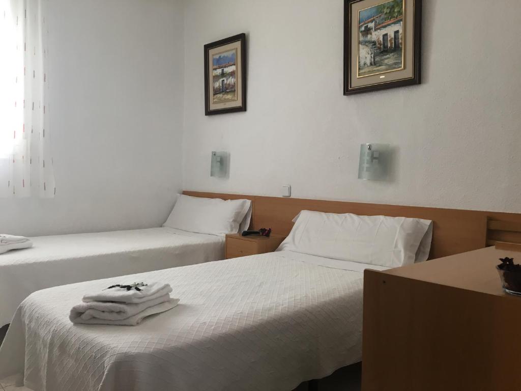 Postel nebo postele na pokoji v ubytování Hostal R. Lido