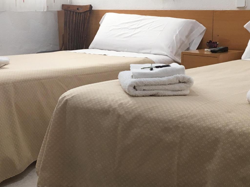 Postel nebo postele na pokoji v ubytování Hostal R. Lido