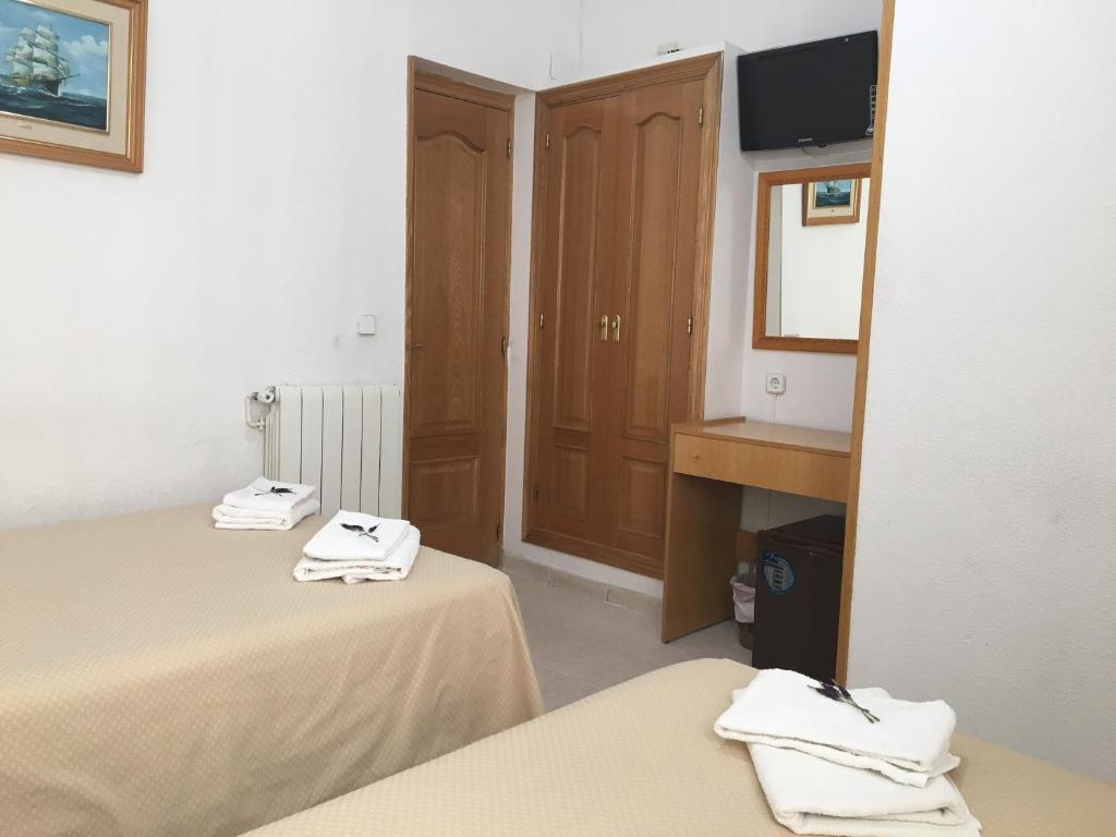 Postel nebo postele na pokoji v ubytování Hostal R. Lido