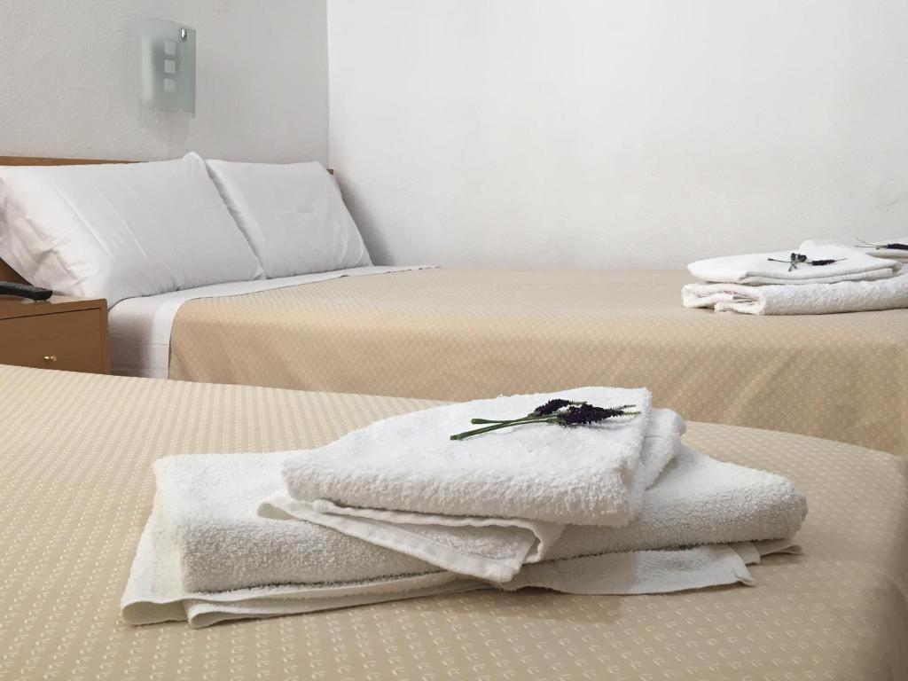 two beds with white towels on top of them at Hostal R. Lido in Madrid