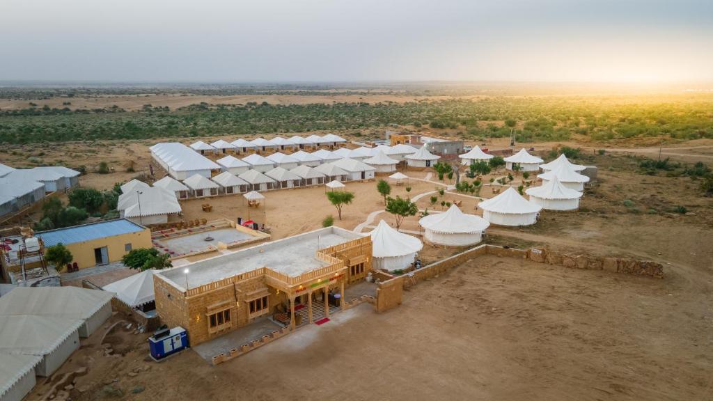an aerial view of a village with white tents at Wild Heritage Desert Camp in Jaisalmer