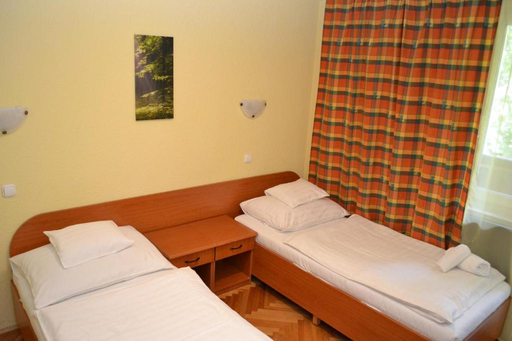 Łóżko lub łóżka w pokoju w obiekcie Ezüstfenyő Hotel