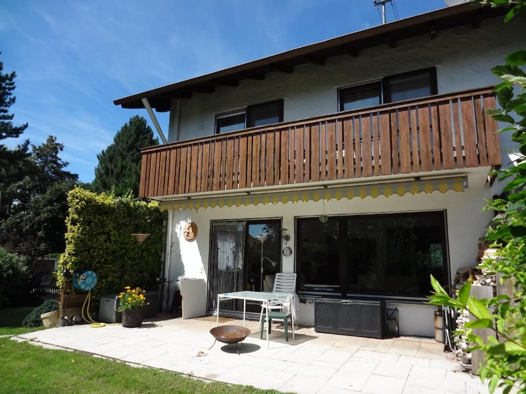 a house with a deck and a patio at Sunny apartment in Pähl in Pähl