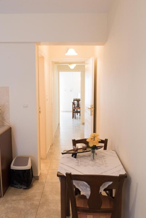 a dining room with a table and a hallway at Vrokastro Apartments in Istro