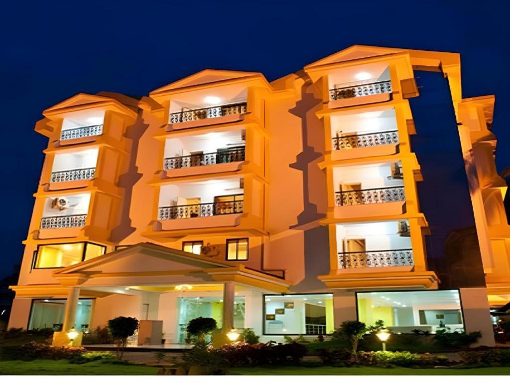 a tall building with an umbrella in front of it at Hotel Colva Kinara in Colva