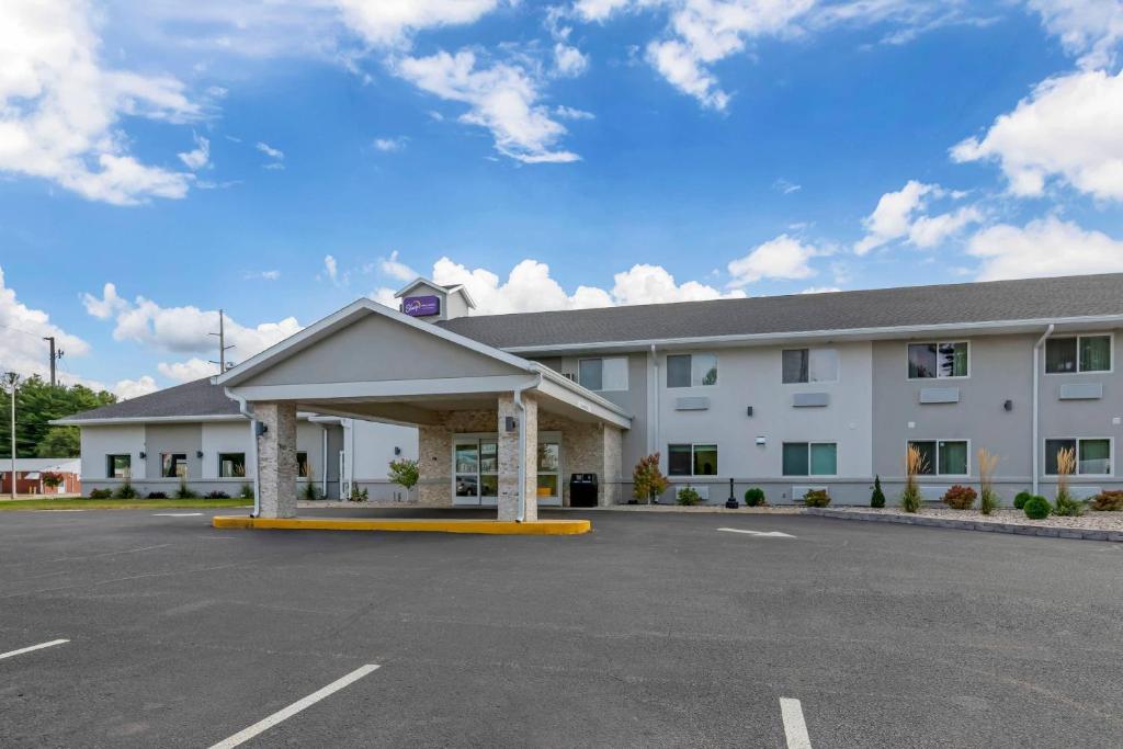 a large white building with a parking lot at Sleep Inn & Suites Wisconsin Dells - Lake Delton in Wisconsin Dells