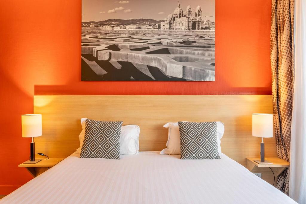 Ένα ή περισσότερα κρεβάτια σε δωμάτιο στο Comfort Aparthotel Marseille Prado
