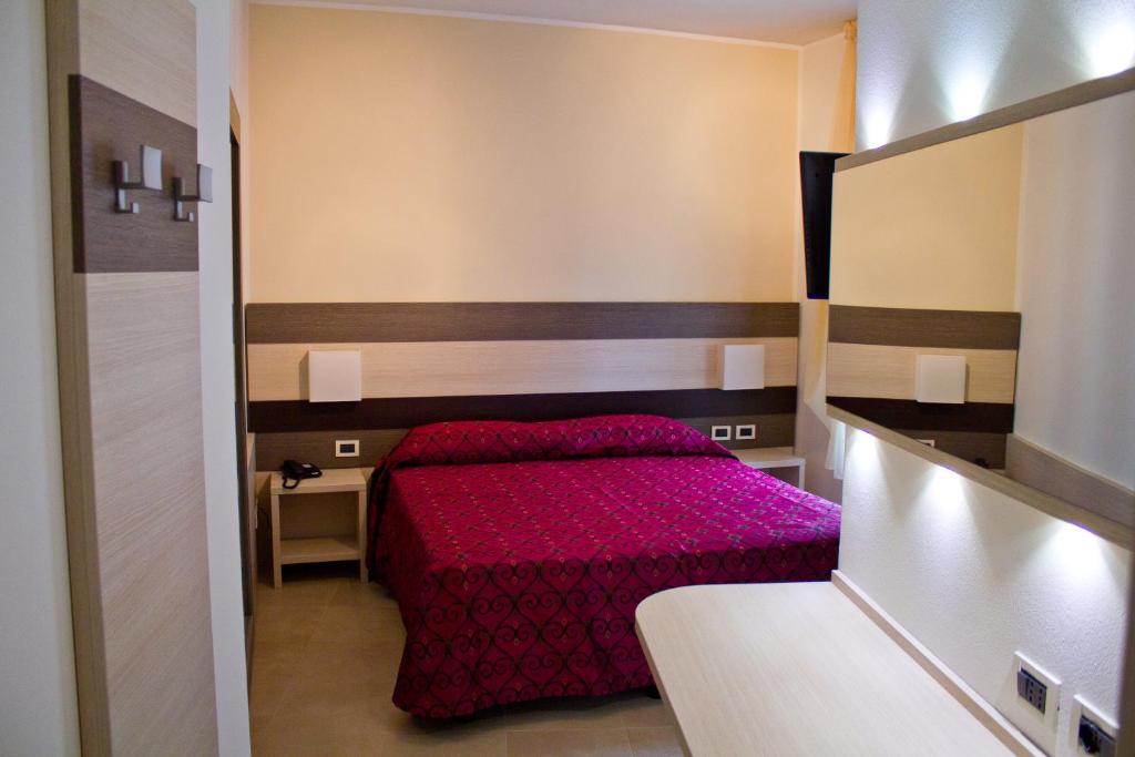 Postel nebo postele na pokoji v ubytování Hotel Siena