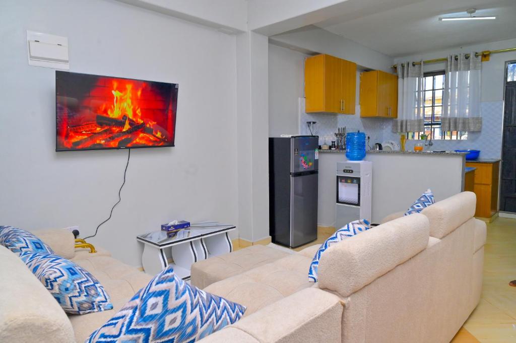 a living room with a couch and a kitchen at gilgalhomes in Gatunga