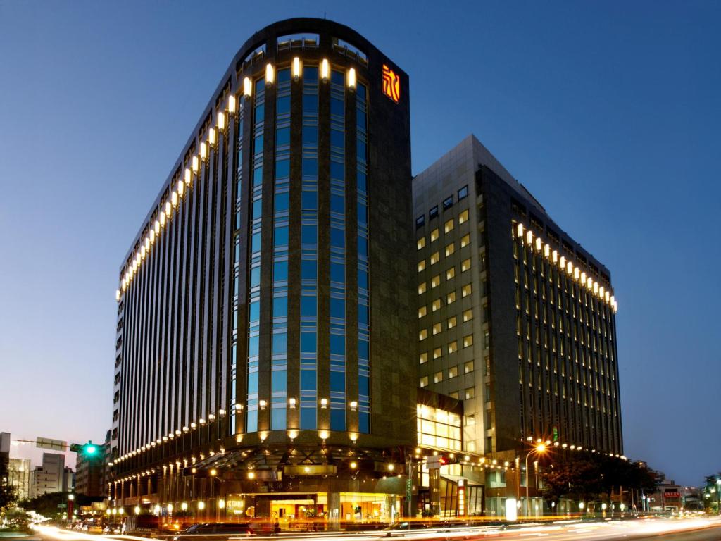 a large building with lights on the side of it at Tempus Hotel in Taichung