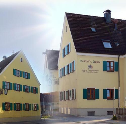 zwei Gebäude sind nebeneinander auf einer Straße in der Unterkunft Gasthof zur Sonne in Jettingen-Scheppach
