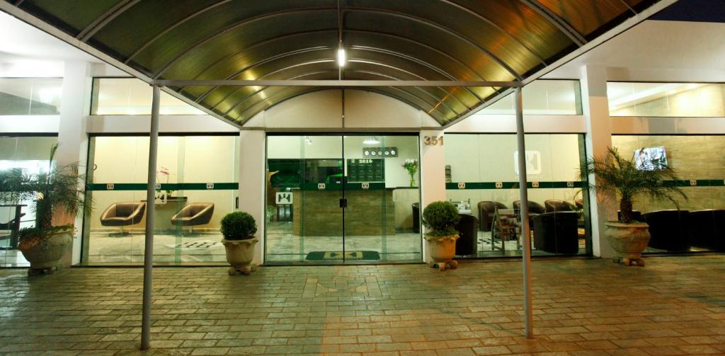 a lobby with potted plants in a building at Hotel Match Point in São Carlos
