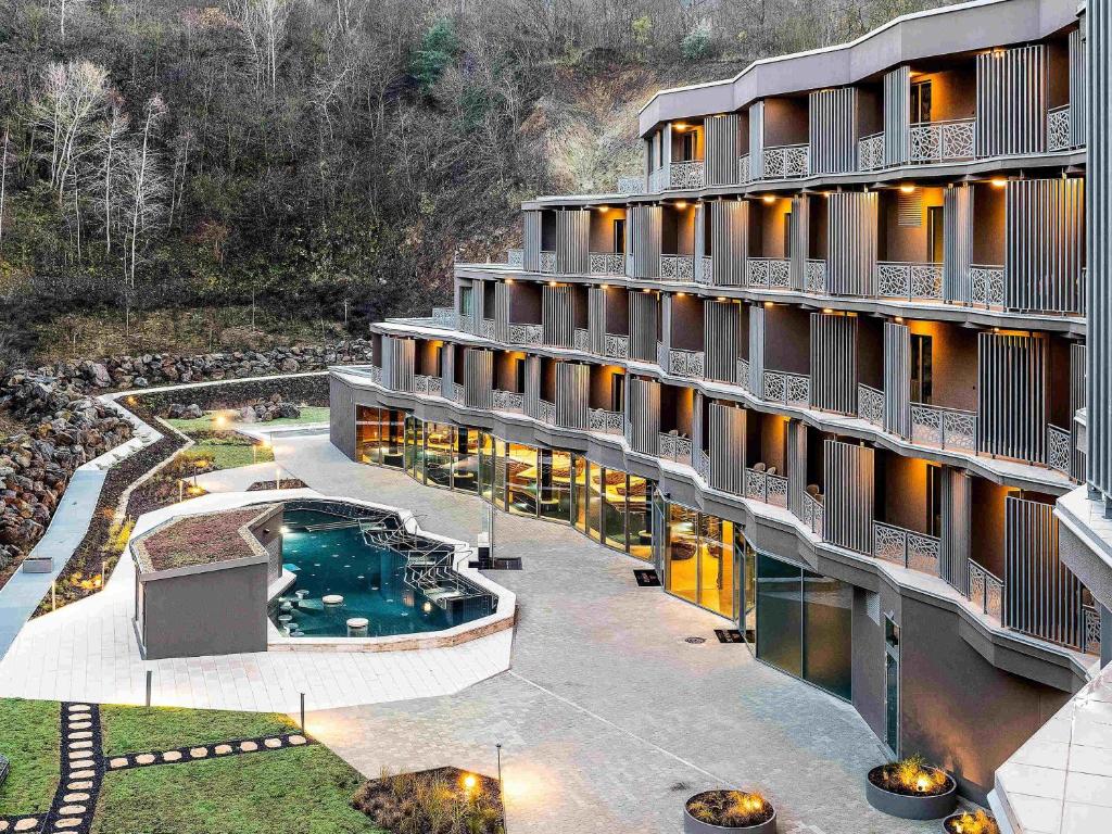 an aerial view of a hotel with a swimming pool at Minaro Hotel Tokaj - MGallery Collection in Tokaj