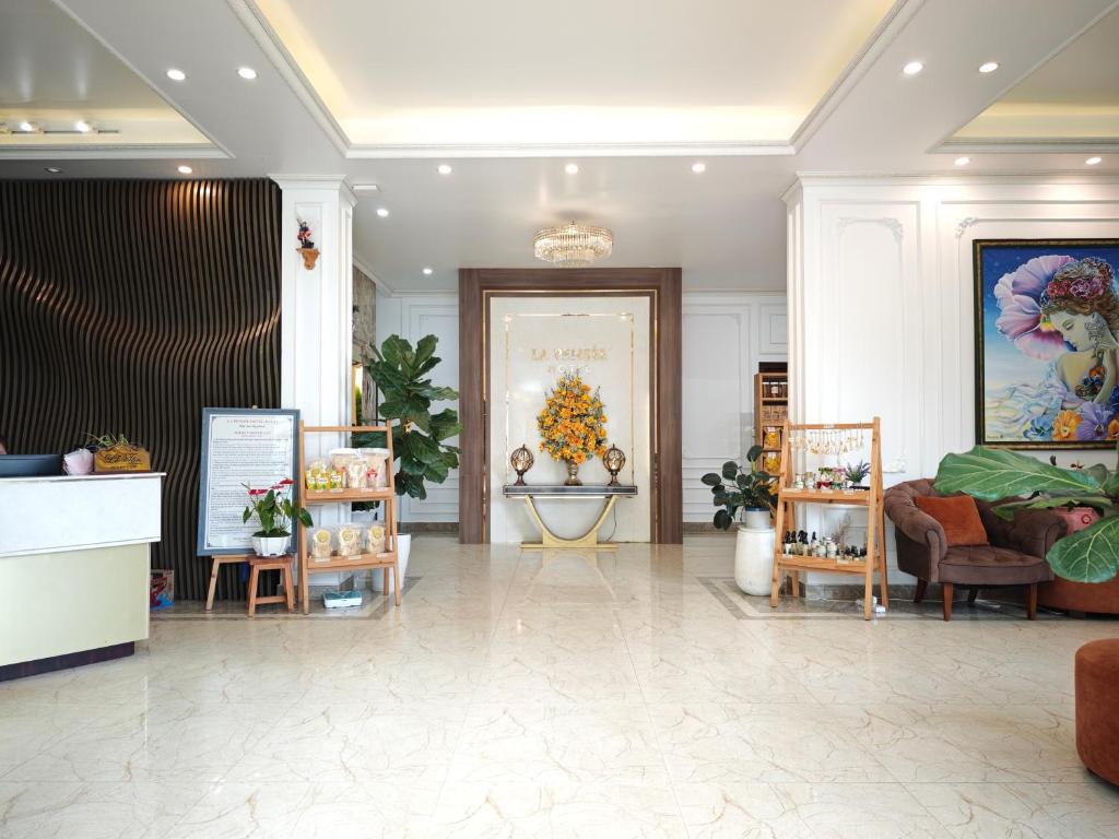 a lobby with a flower shop with tables and chairs at La Pense'e Hotel - Dalat in Da Lat