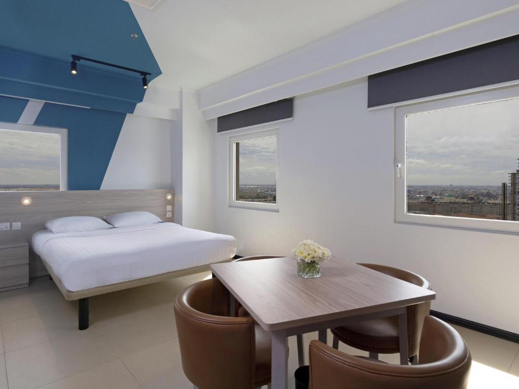 Giường trong phòng chung tại ibis budget Phnom Penh Riverside