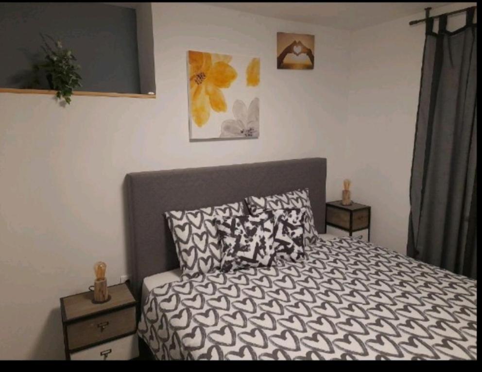 a bedroom with a bed and two night stands at Apartman Green Dream Fužine in Fužine