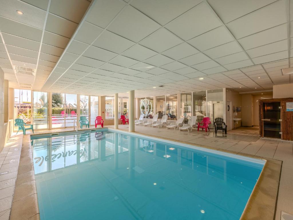 a large swimming pool in a large building at D de Bertheaume N104 2P6 in Plougonvelin
