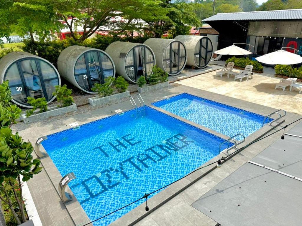 a swimming pool with the words the bathrooms written on it at The Cozytainer in Taiping