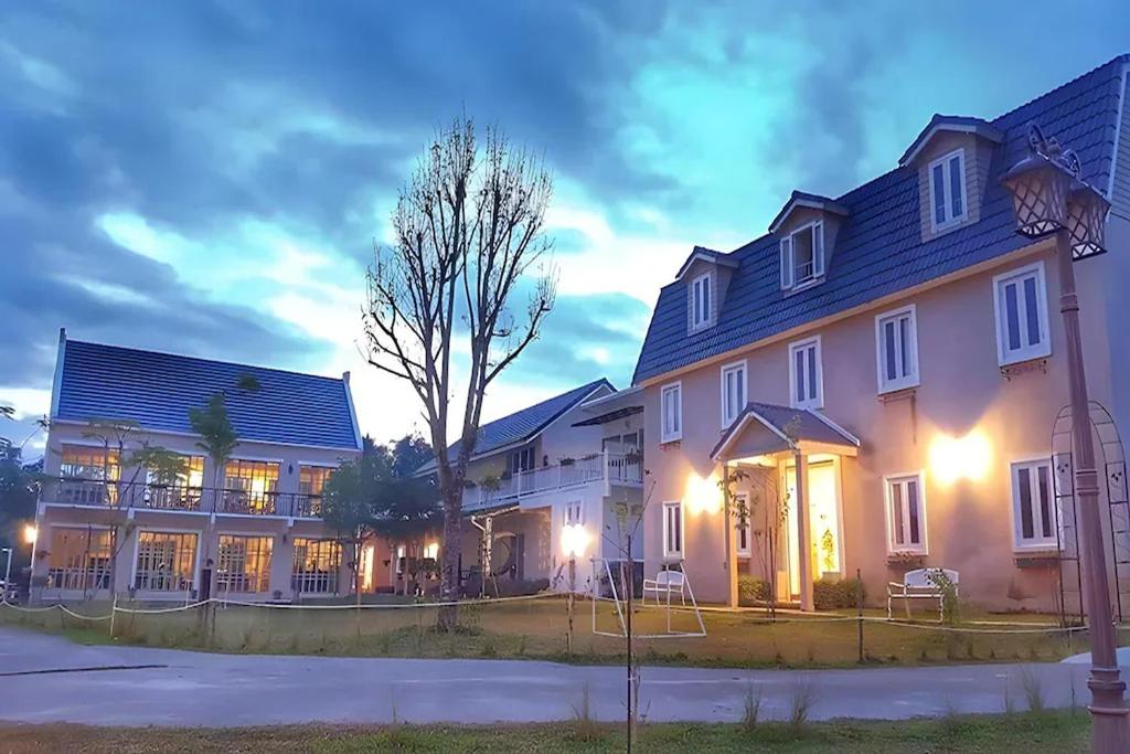 a large house with a tree in front of it at Doi Tung View Resort in Mae Sai