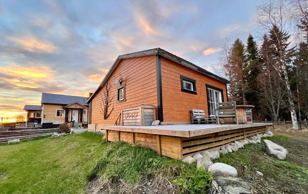 a home with a deck and a house at Go out stay wild in Norsjö