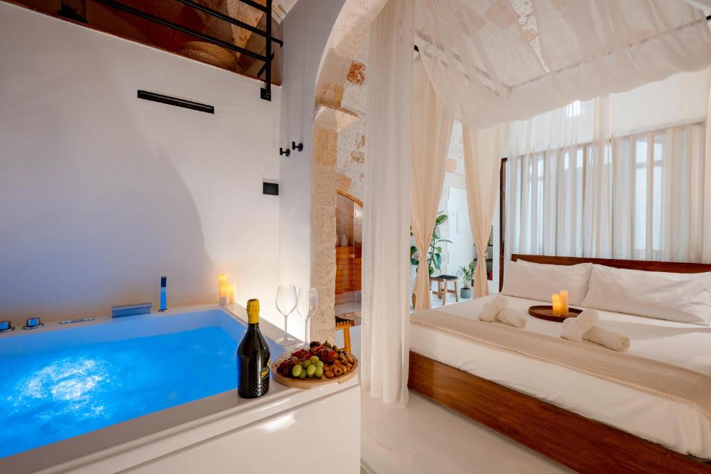 a bedroom with a bed and a bath tub at Archè Luxury private Spa in Polignano a Mare