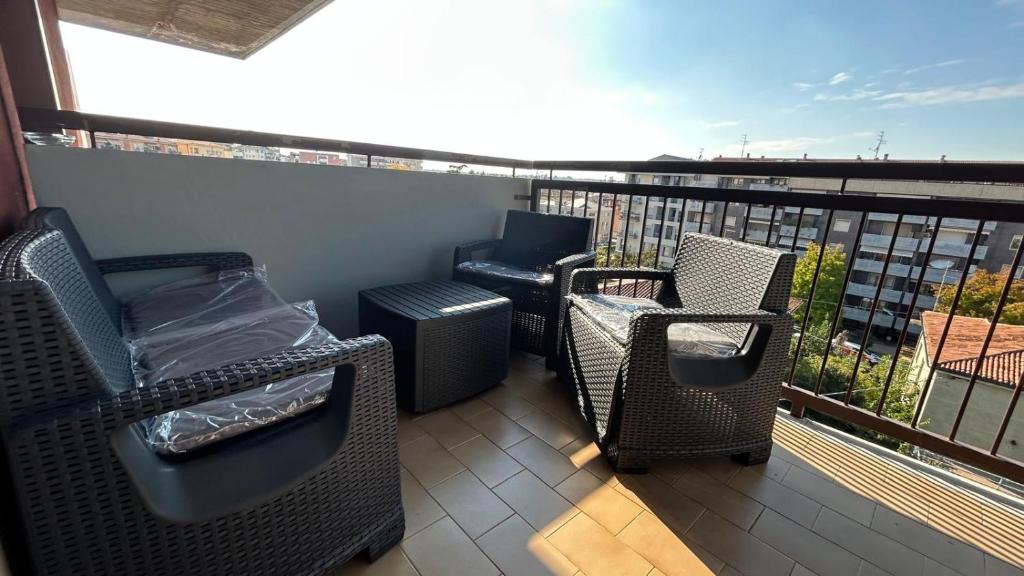 a balcony with chairs and a heater on a balcony at Skyline Verona in Verona