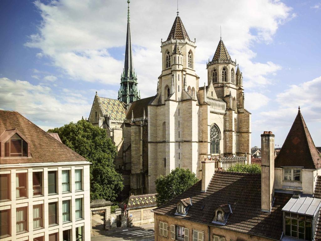 an old church with two towers in a city at Mama Shelter Dijon in Dijon