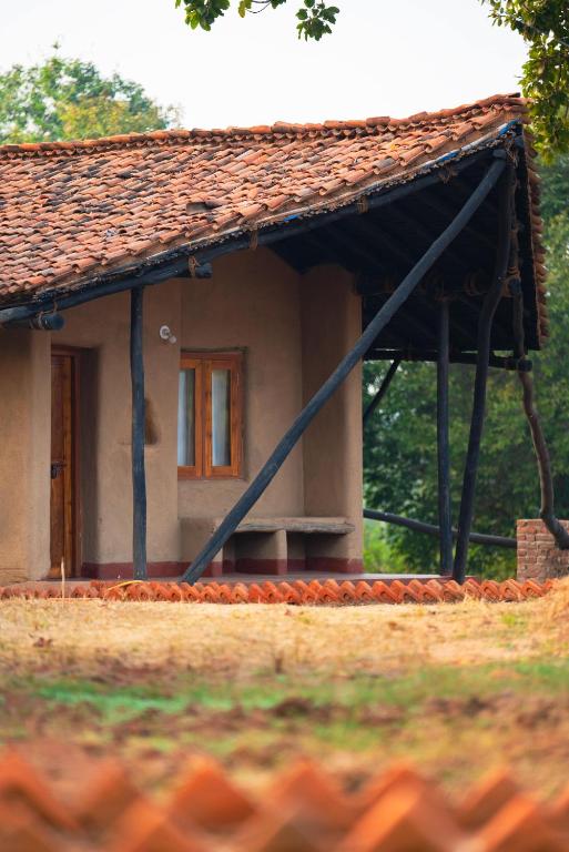 a small house with a bench in front of it at Sakhua stays in Tāla