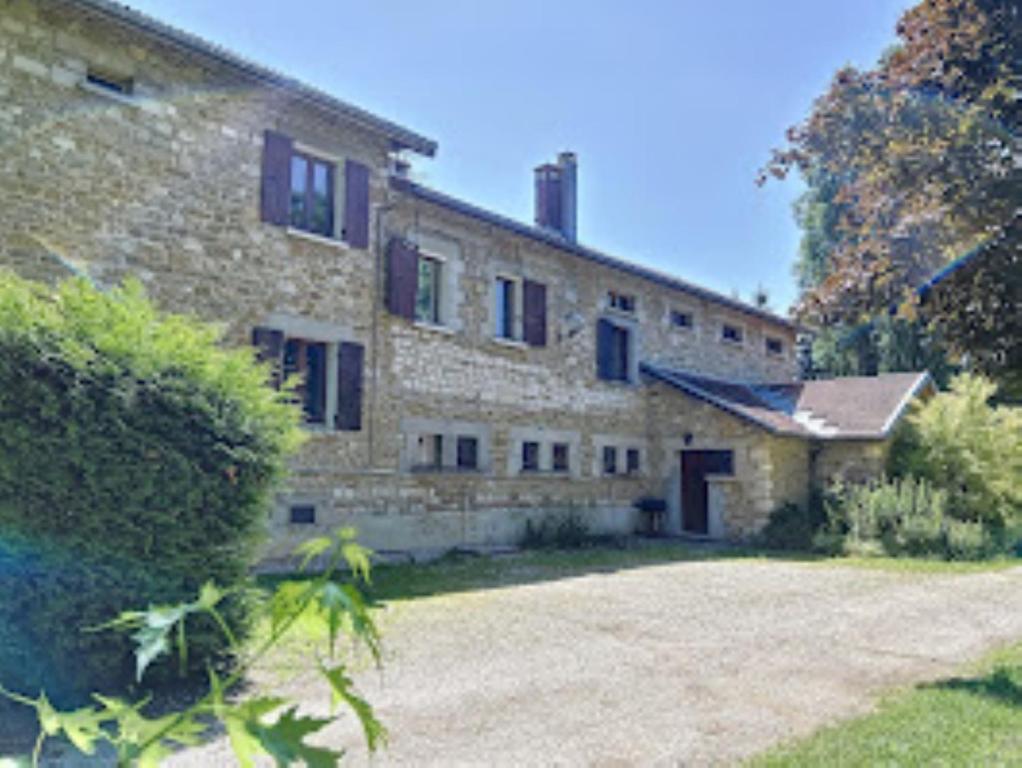 a large stone building with a yard in front of it at Chambres d'hôtes LA CHAPELAINE in La Chapelle-en-Vercors