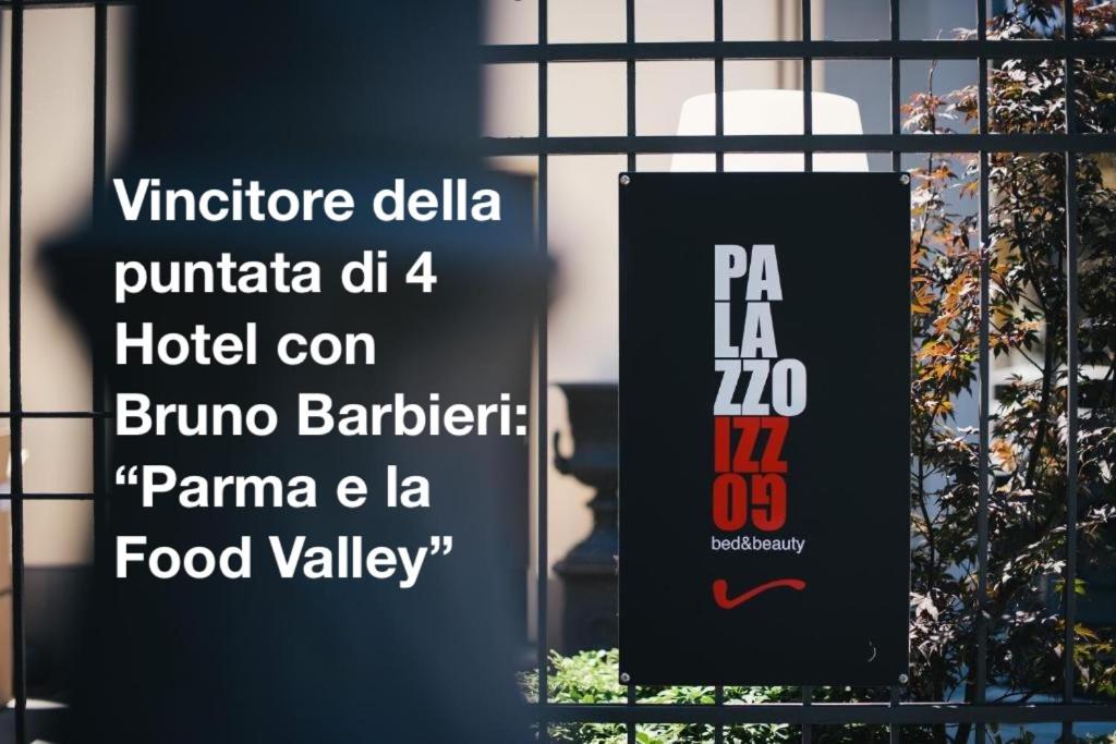 a sign in front of a window of a building at Palazzo Gozzi Bed & Beauty in Parma